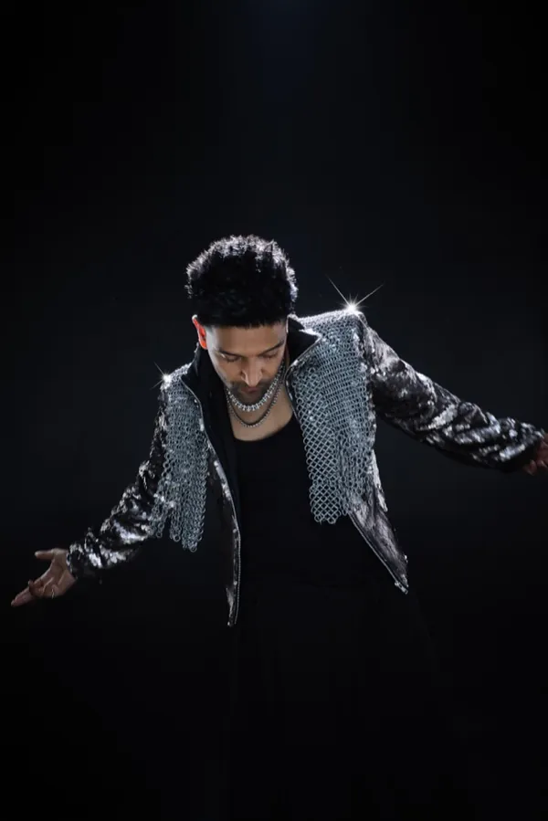 Guru Randhawa mid-move, arms spread