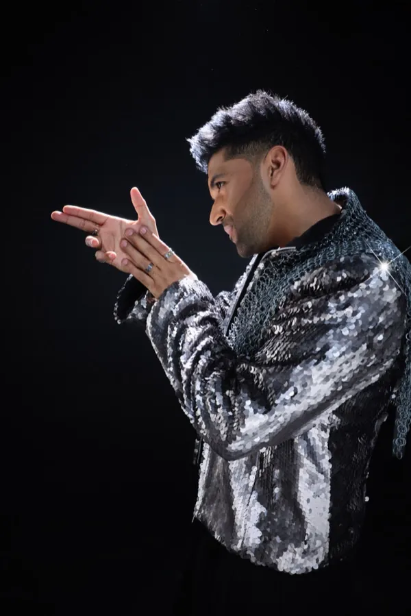 Guru Randhawa in profile, in a silver sequin jacket