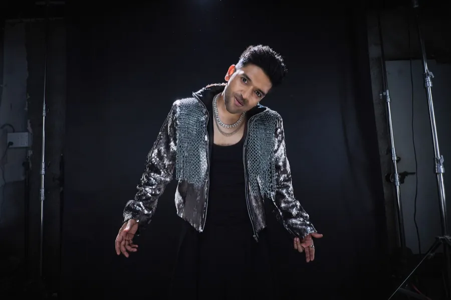 Guru Randhawa on an empty stage, arms loose at his sides